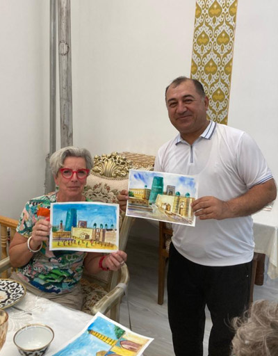 Portrait of Abdu Samadov holding a watercolor sketch